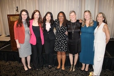 Pictured (left-right) Lori Montgomery, Niquole Caringi, Daniella Mizhericher, Tracey Brame, Marla Mitchell-Cichon, Ann Garant, and Robyn Frankel members of Cooley Law School’s Innocence Project, who served while Mitchell-Cichon was director of the clinic.