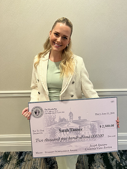 Sarah Tanner holding large check